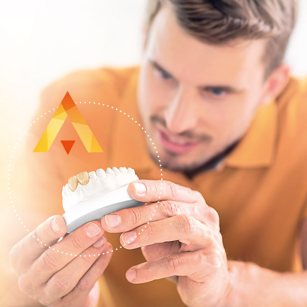 Dental technician inspects anterior tooth crowns fabricated from VITA Press Ceramic Dental technician inspects anterior tooth crowns fabricated from VITA Press Ceramic