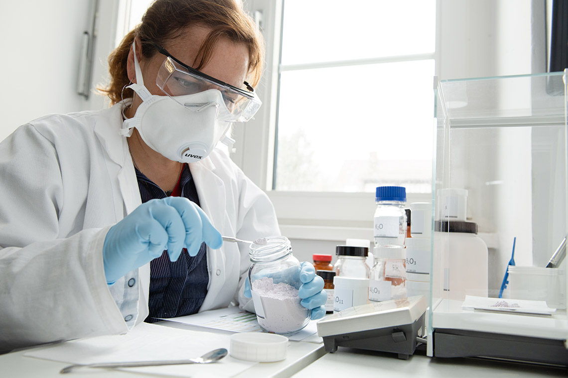 VITA employee weighing raw materials for the development of a press ceramic