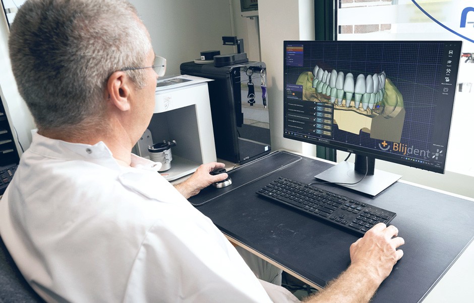 Ralph van der Reijden überprüft am Computer die virtuelle Aufstellung der Zähne
